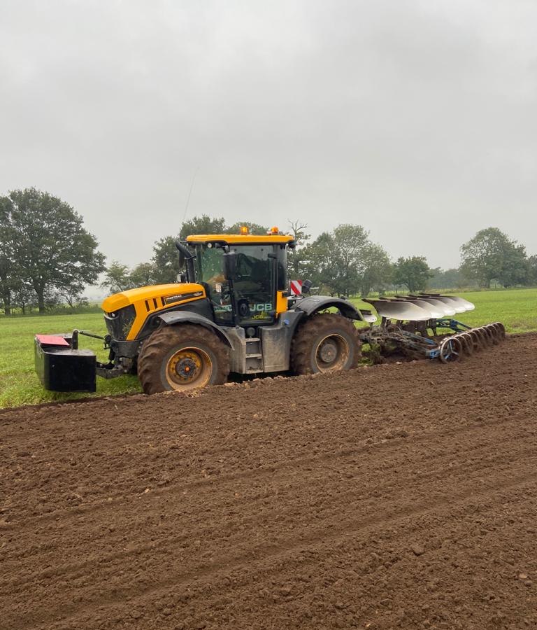 Glover Agricultural Services tractor cultivating a field.