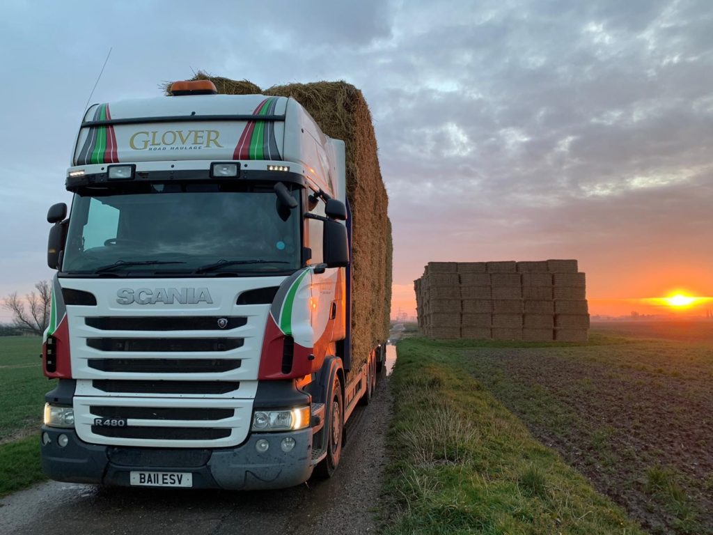 Glover Haulage lorry leaving with a full trailer of stacked bales